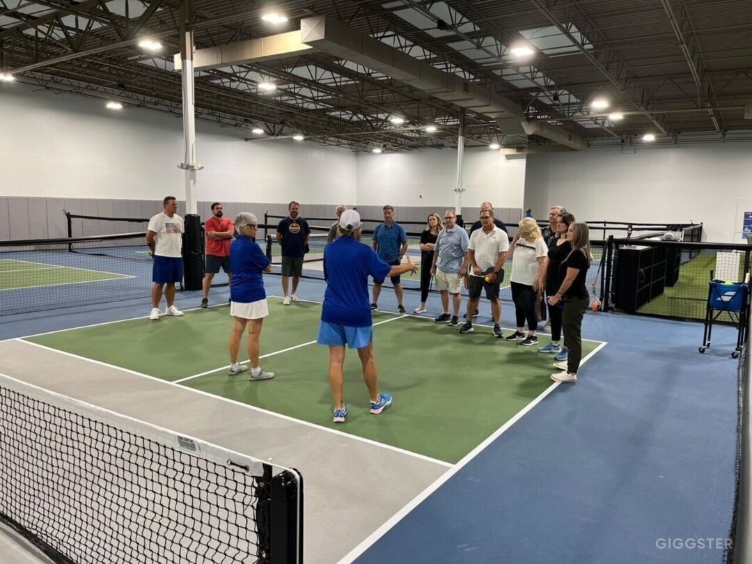 Indoor pickleball courts and permanent fencing at Bangers & Dinks, from its Giggster listing